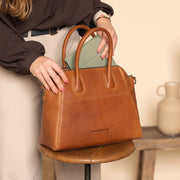 Styled Fit Perspective of Marsala Full-Grain Leather Handbag Naisille on Model - Natural Daylight Drape